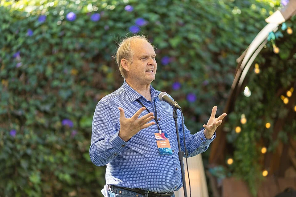 Robin Hanson speaking on stage at Manifest 2023.